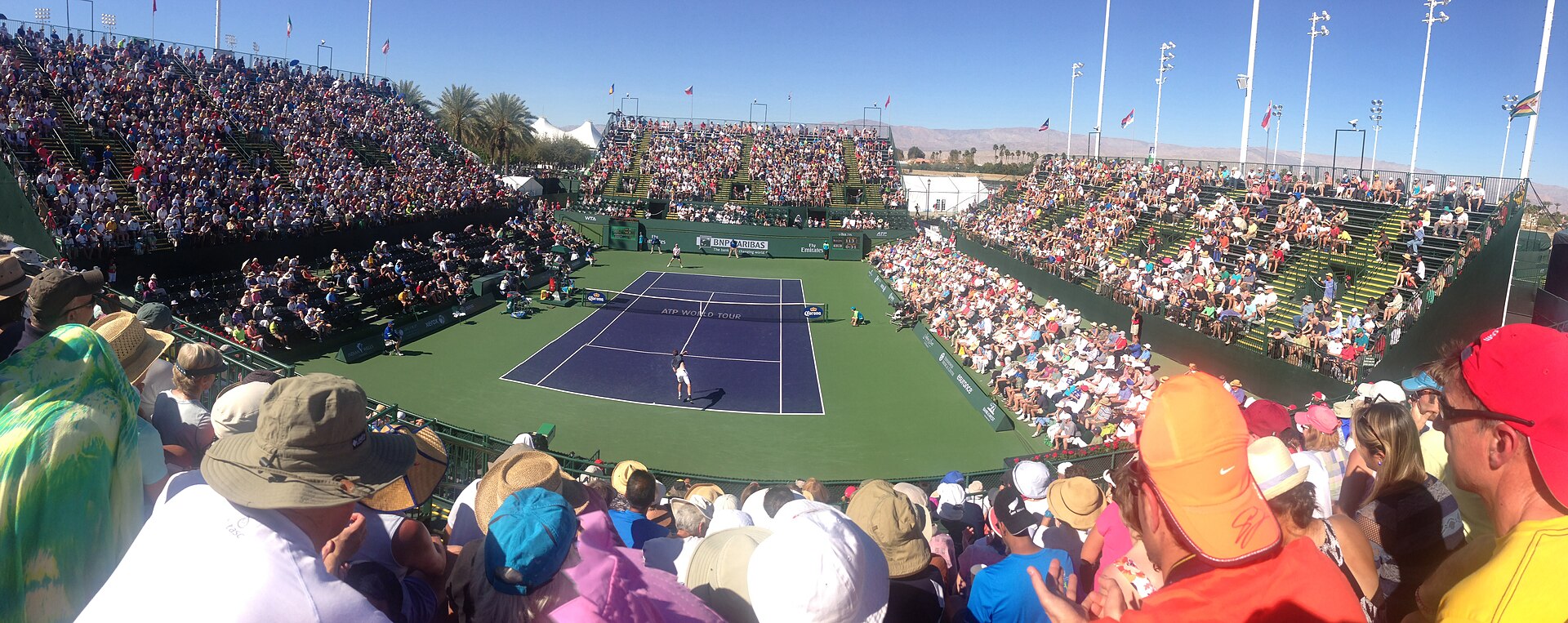 A tennis court seen from the stands during a match